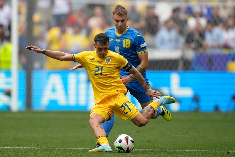 Nicolae Stanciu kicks the ball against Ukraine